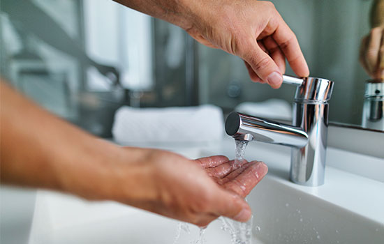 hand under running tap water