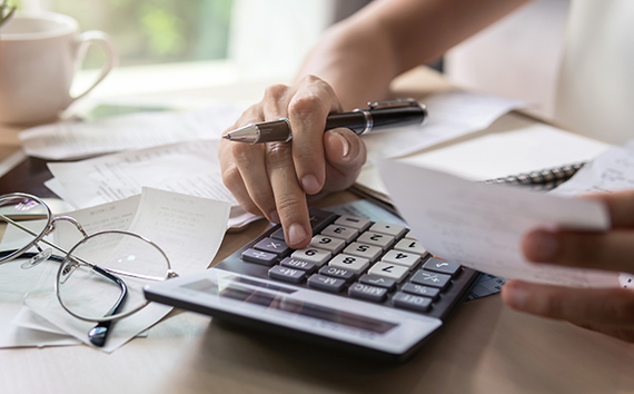 customer paying bills with calculator