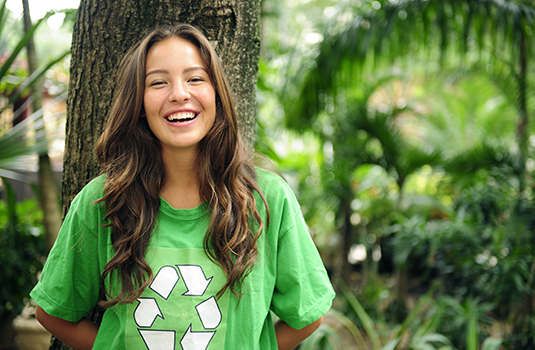 Environmental activist in the forest wearing a recycle t-shirt
